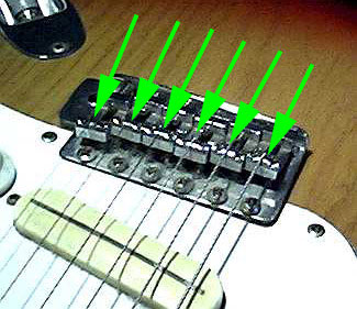 Guitar bridge assembly with individual mount and adjustable screw for setting intonation of each string