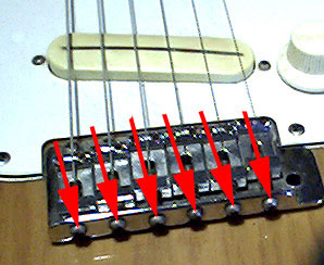 The guitar intonation adjustment screws as found on some brands and models of electric guitars